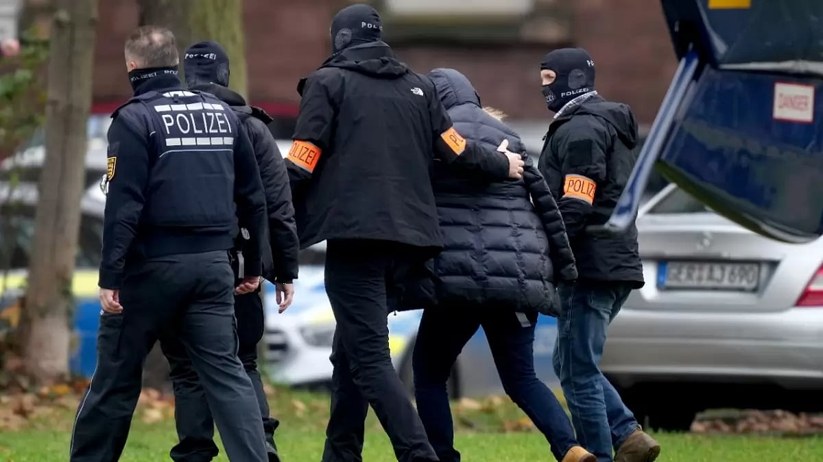 A suspected far-right extremist being arrested by German law-enforcement personnel
