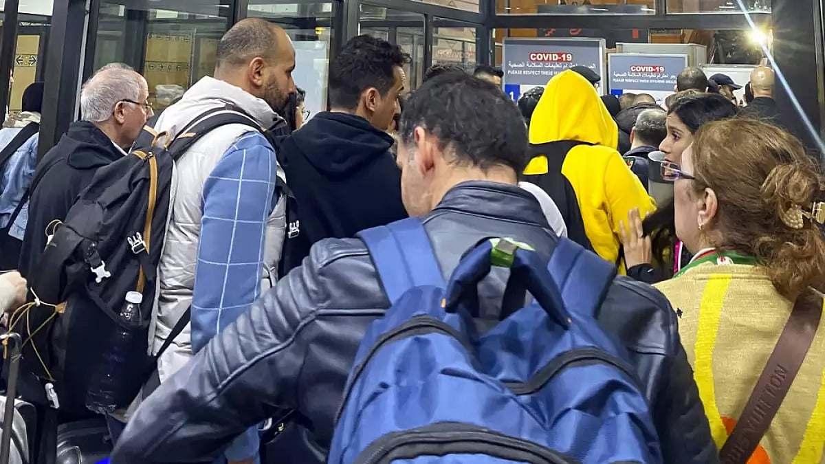 Moroccan football fans queue up at Casablanca airport after their flights were cancelled.