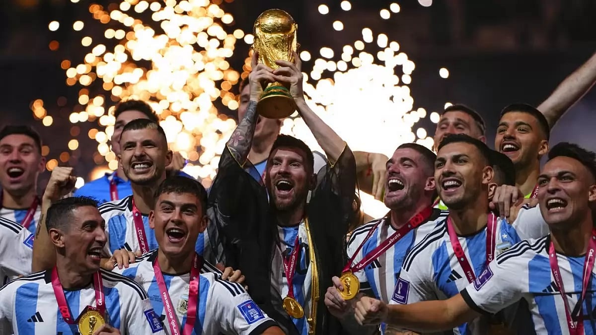 Lionel Messi holds the trophy aloft as Argentina celebrate their win over France on Sunday.