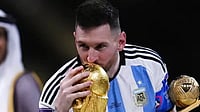 Lionel Messi kissing the World Cup trophy at Lusail Stadium, Qatar