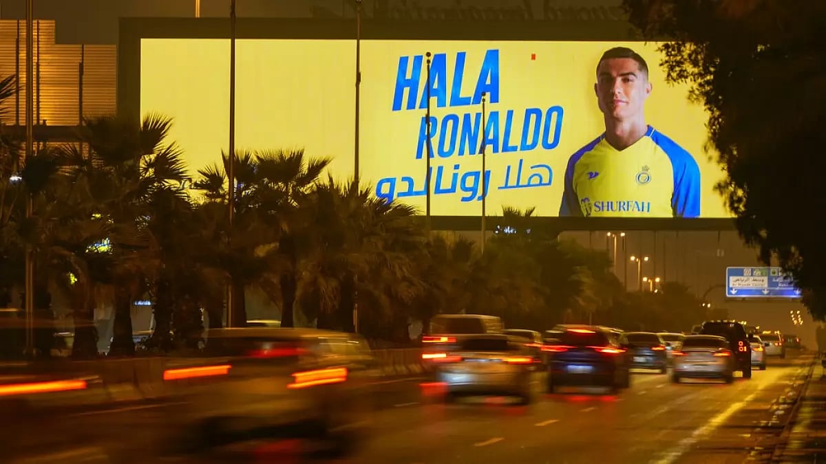 Vehicles pass by 'Welcome Ronaldo' hoarding in Riyadh.