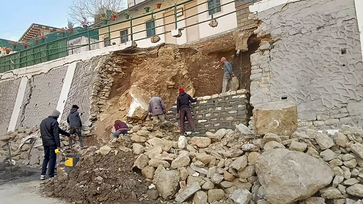Repair work underway following collapse of a wall in Joshimath area of Chamoli district. The town has been declared a disaster-prone area after large cracks appeared in homes and on roads.