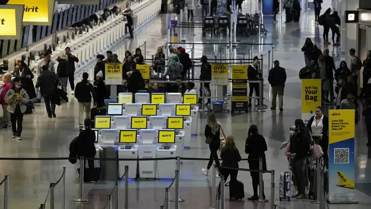 People check into their flights at Harry Reid International Airport, Wednesday, Jan. 11, 2023, in La