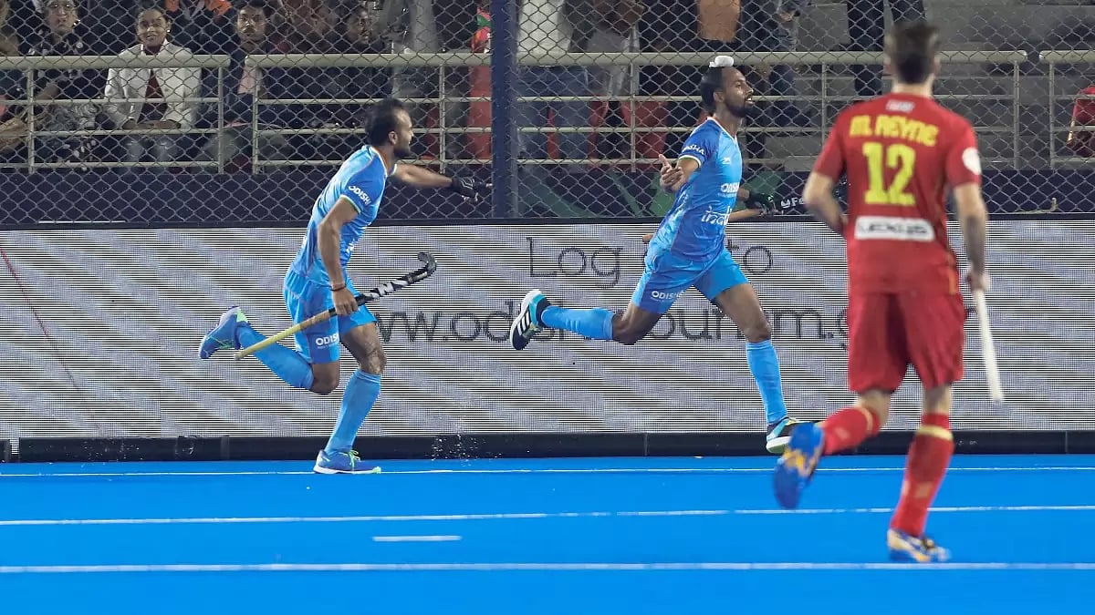 Hardik Singh, centre, celebrates after scoring IND's second goal against Spain.