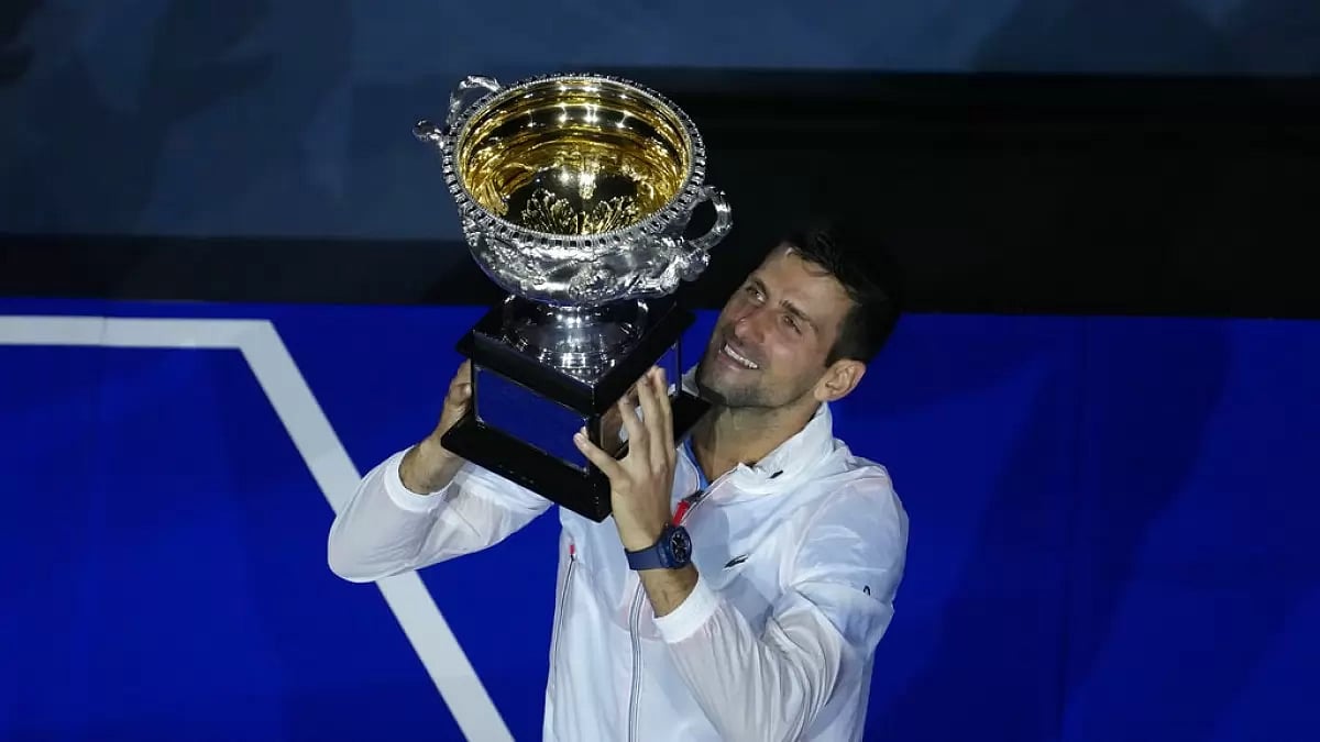 Djokovic celebrates with the Australian Open trophy after defeating Tsitsipas on Sunday.