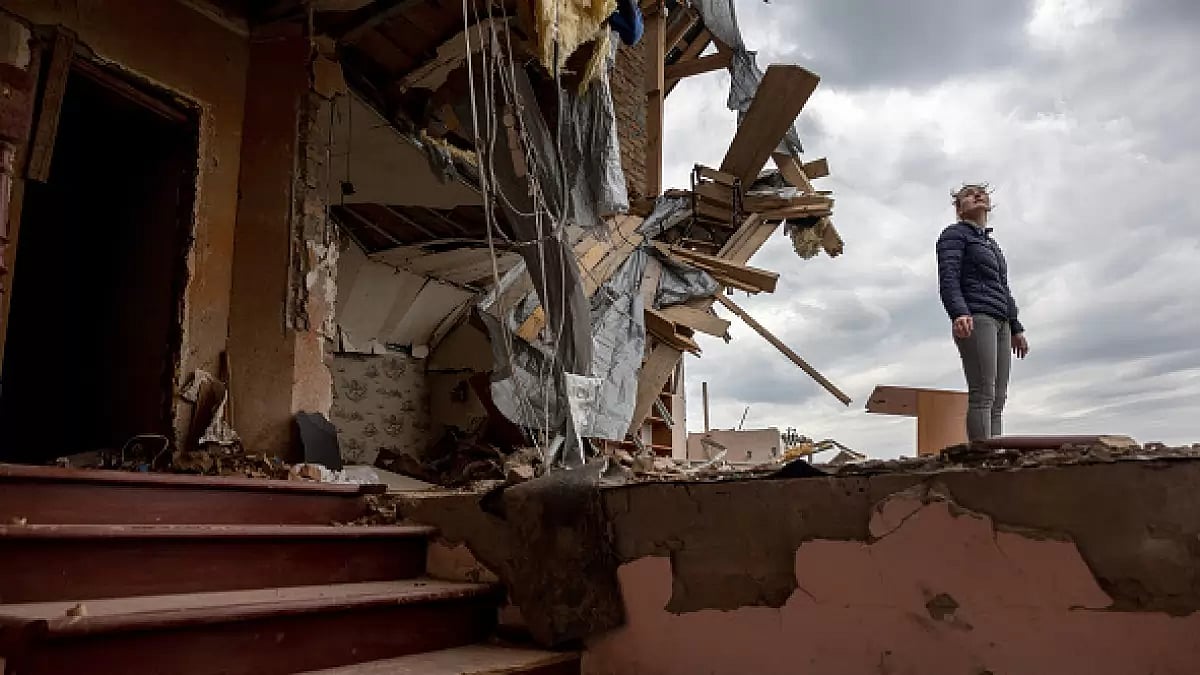 HOSTOMEL, UKRAINE - Oksana surveys the destroyed second floor of her multi-generational home - null