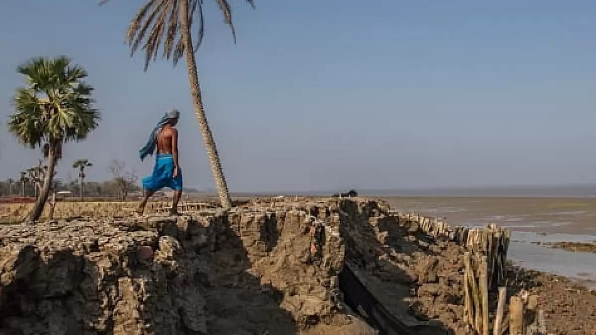 On Sagar island, Saheb Dalui walks along a man-made seawall