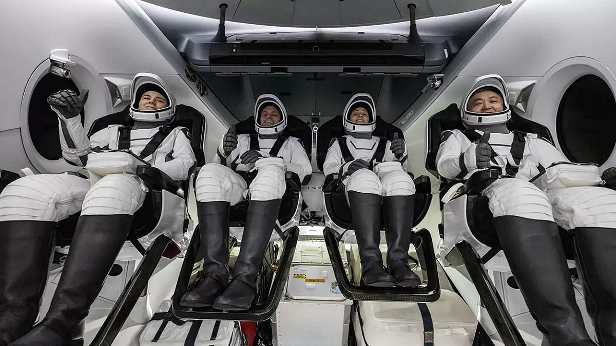 NASA and JAXA astronauts inside the SpaceX Dragon