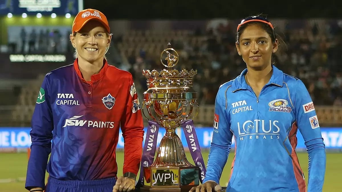 Meg Lanning and Harmanpreet Kaur pose with the WPL trophy after the toss on Sunday.