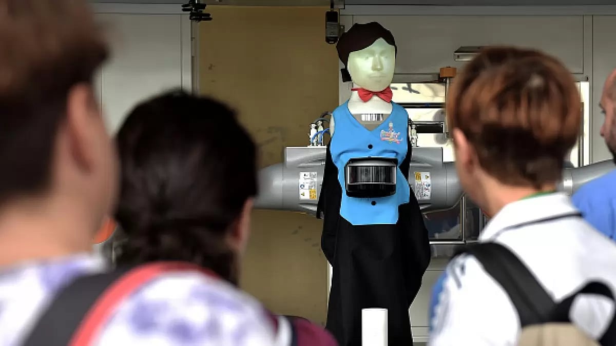 Will Artificial Intelligence replace humans in jobs? A robot bartender displays his skills in front  - null