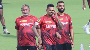 File : Bharat Arun, left, with Narine and Chakravarthy during a KKR practice session.