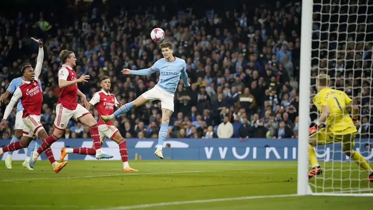 Manchester City's John Stones, center, scores his side's second goal against Arsenal.