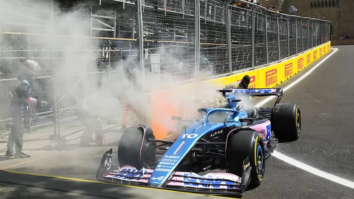 Gasly, left, watches smoke billowing from his car during FP1 in Azerbaijan on Friday.