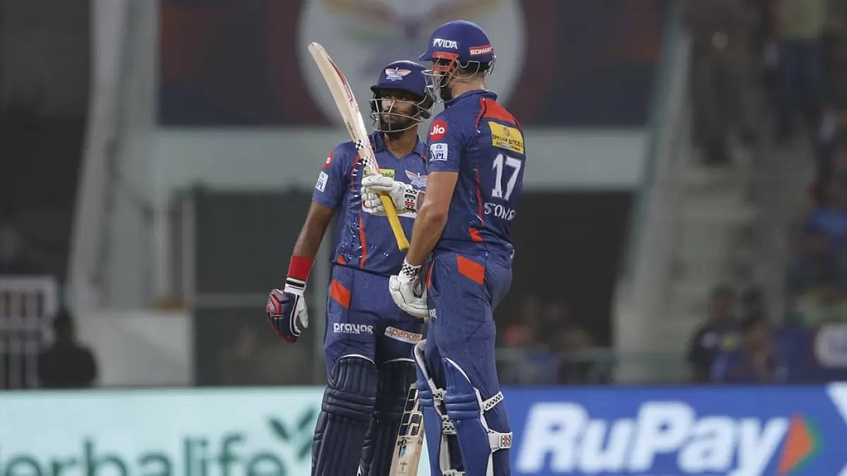 Stoinis raises his bat after reaching his fifty against MI in Lucknow on Tuesday.