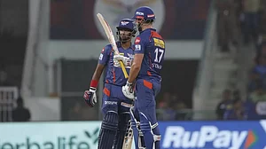 Stoinis raises his bat after reaching his fifty against MI in Lucknow on Tuesday.