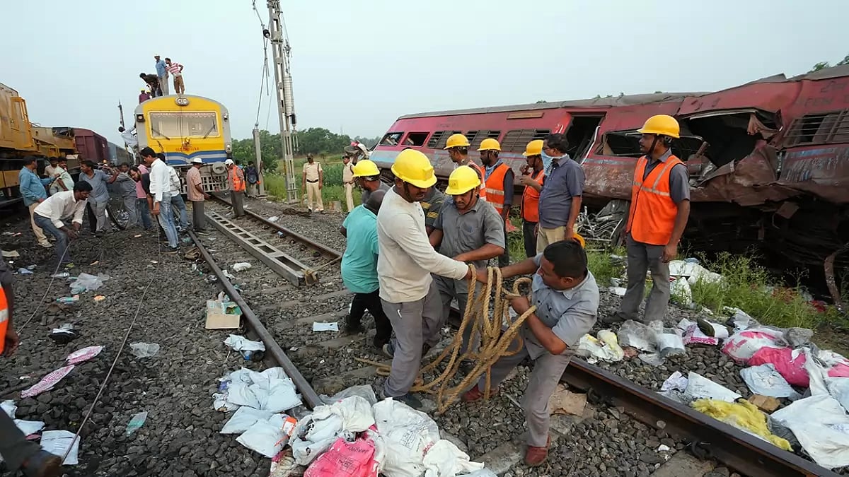 Workers restore railway tracks at the end of rescue and search operation after an accident involving three trains, near Bahanga Bazar railway station in Balasore district. 