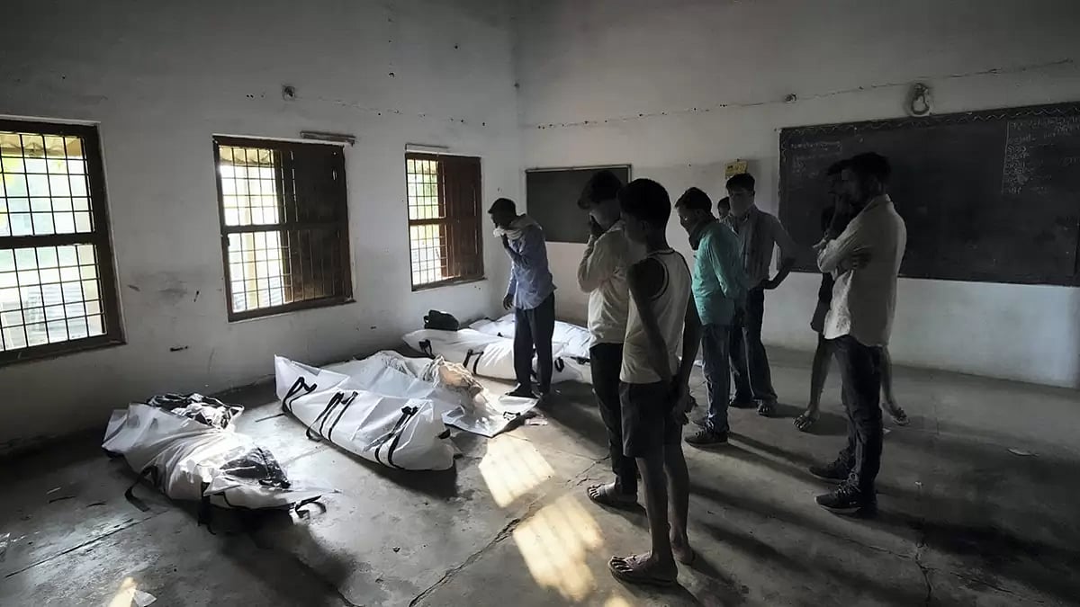 Relatives of victims identify the bodies of their loved ones at a temporary mortuary at Bahanaga High School