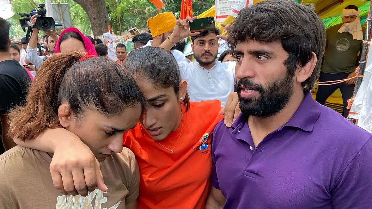 Indian wrestlers, from right, Bajrang Punia, Sangita Phogat and Vinesh Phogat talk to each other ahe