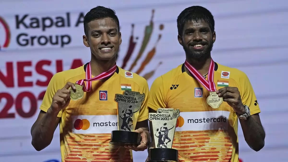 Chirag, left, and Satwik celebrate with their medals and trophies in Jakarta on Sunday.