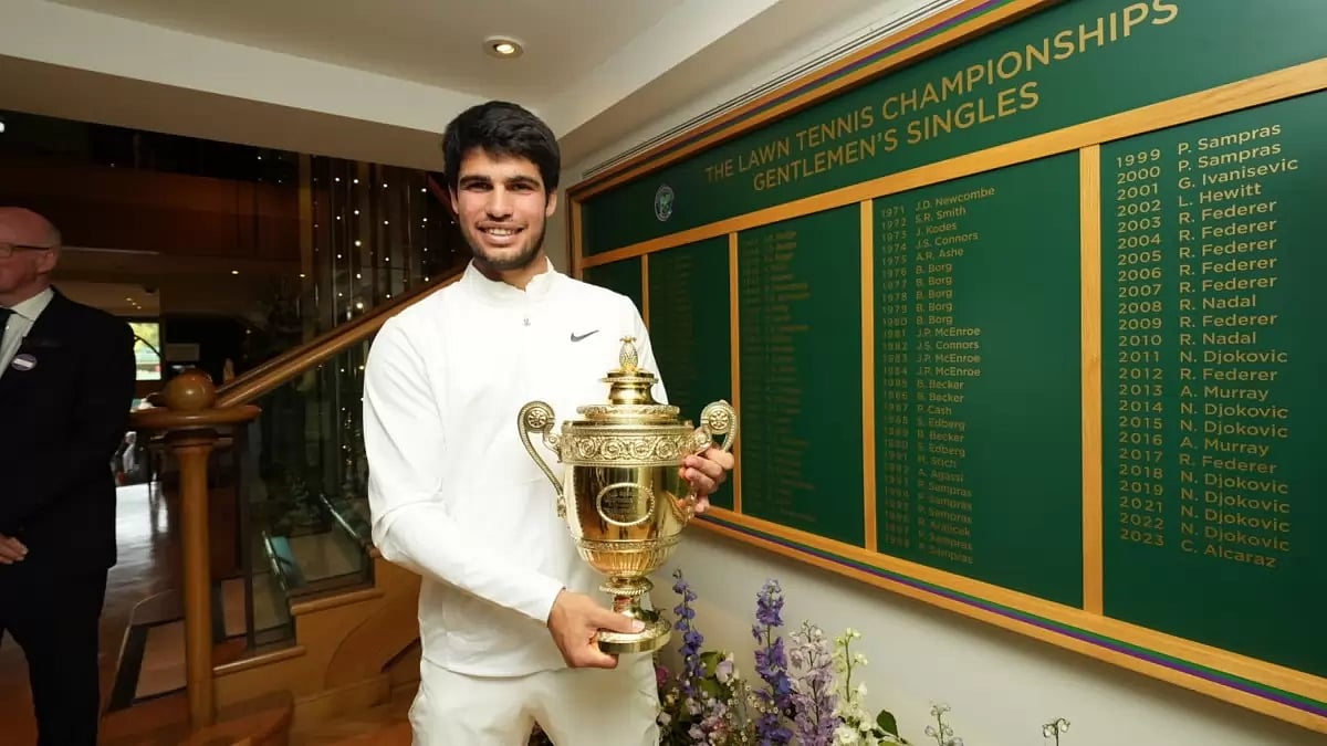 Carlos Alcaraz poses with the trophy after his gruelling win over Novak Djokovic.