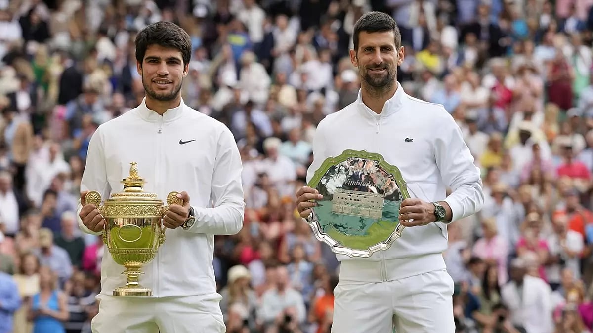 Carlos Alcaraz, left, with Wimbledon trophy after beating Novak Djokovic (R) - null