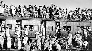 Turmoil of Partition: Refugees sit on the roof of a train trying to flee India