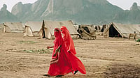 How Language Barricade Impacts Refugees In A Faraway Land Lonely Lives: Two refugees from Eritrea, Ethiopia walk past a refugee camp in East Sudan