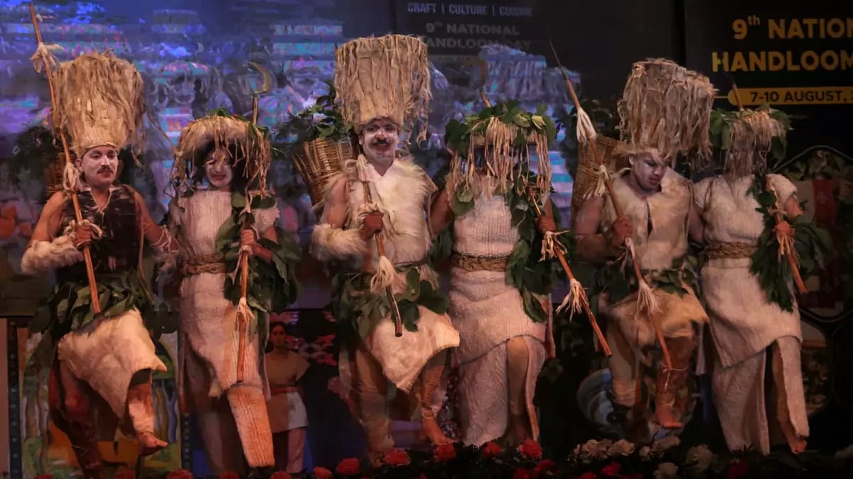 The Hatti community members performing their traditional dance in a theatre.