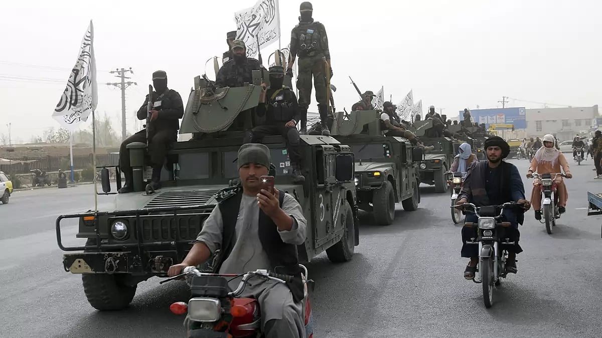 Taliban fighters patrol on the road