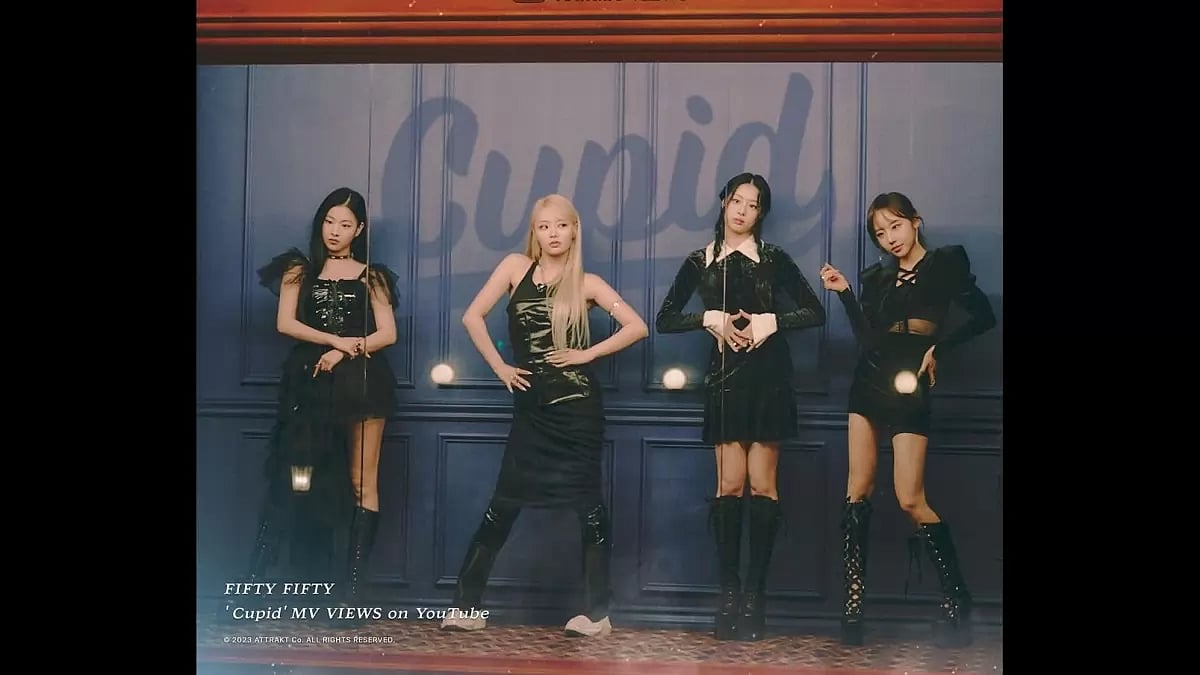 FIFTY FIFTY members celebrating 100 million views on 