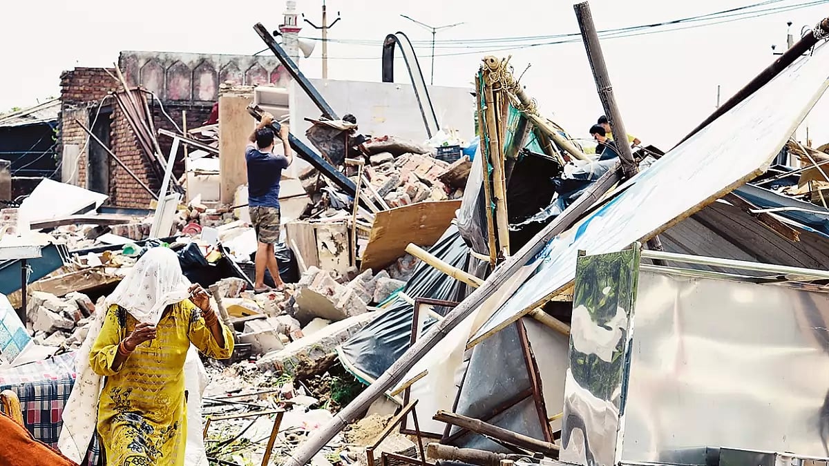 Locals searching for their belongings after shops outside the Medical College in Nuh were demolished