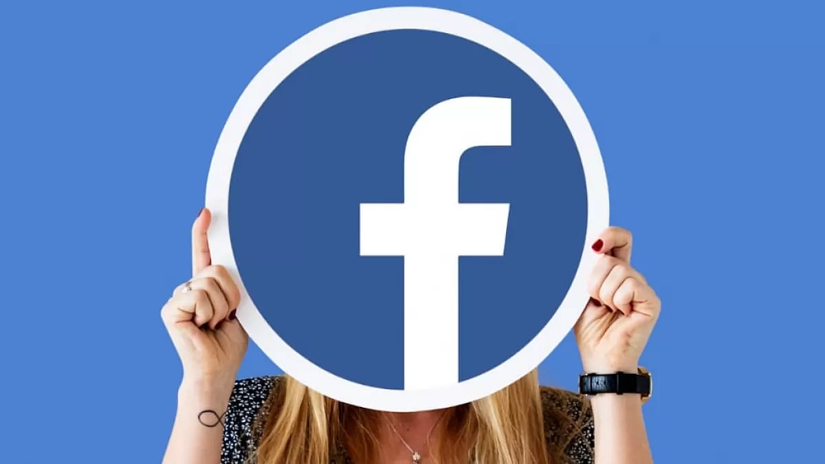 A Woman Holding a Facebook Logo