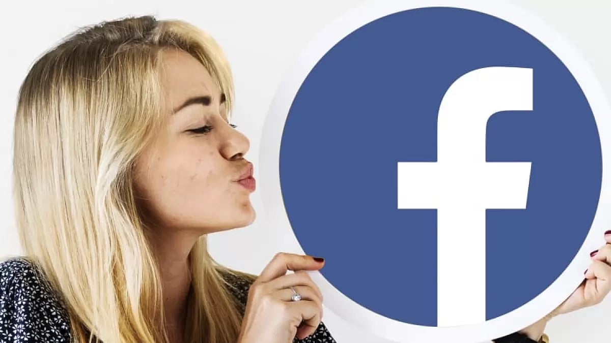 A woman holding the logo of Facebook