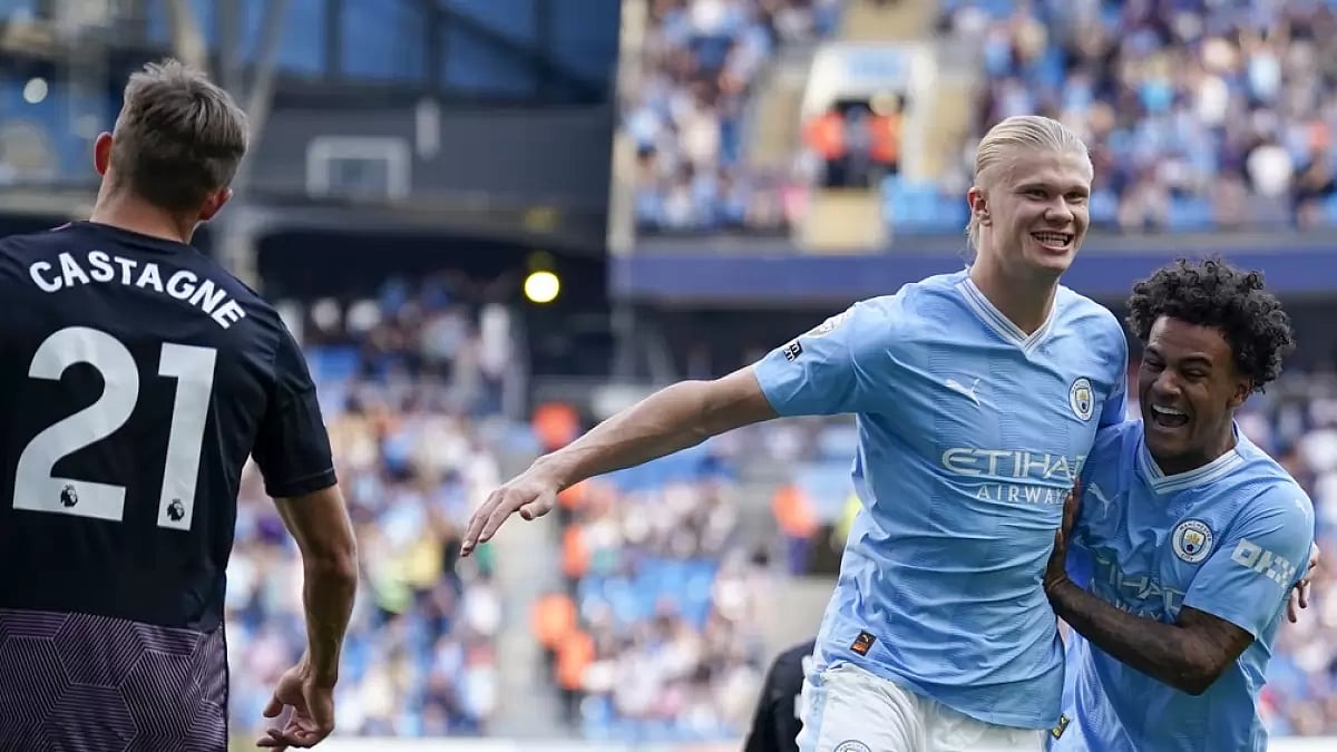 Erling Haaland (R) celebrates a goal as Manchester City thumped Fulham at the Etihad.