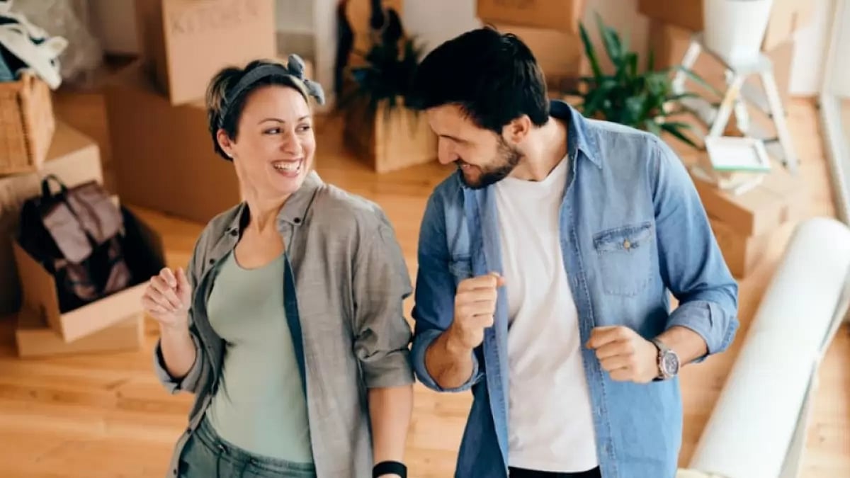 Young Couple Dancing After Buying New House in Canada.