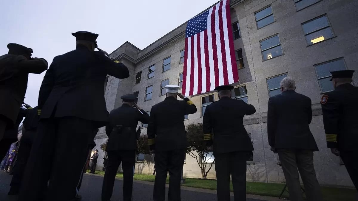 First responders salute as an American flag is unfurled at the Pentagon 
