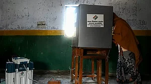 A voter casts her ballot at a polling station in Vrindavan on February 10, 2022 during the 1st Phase
