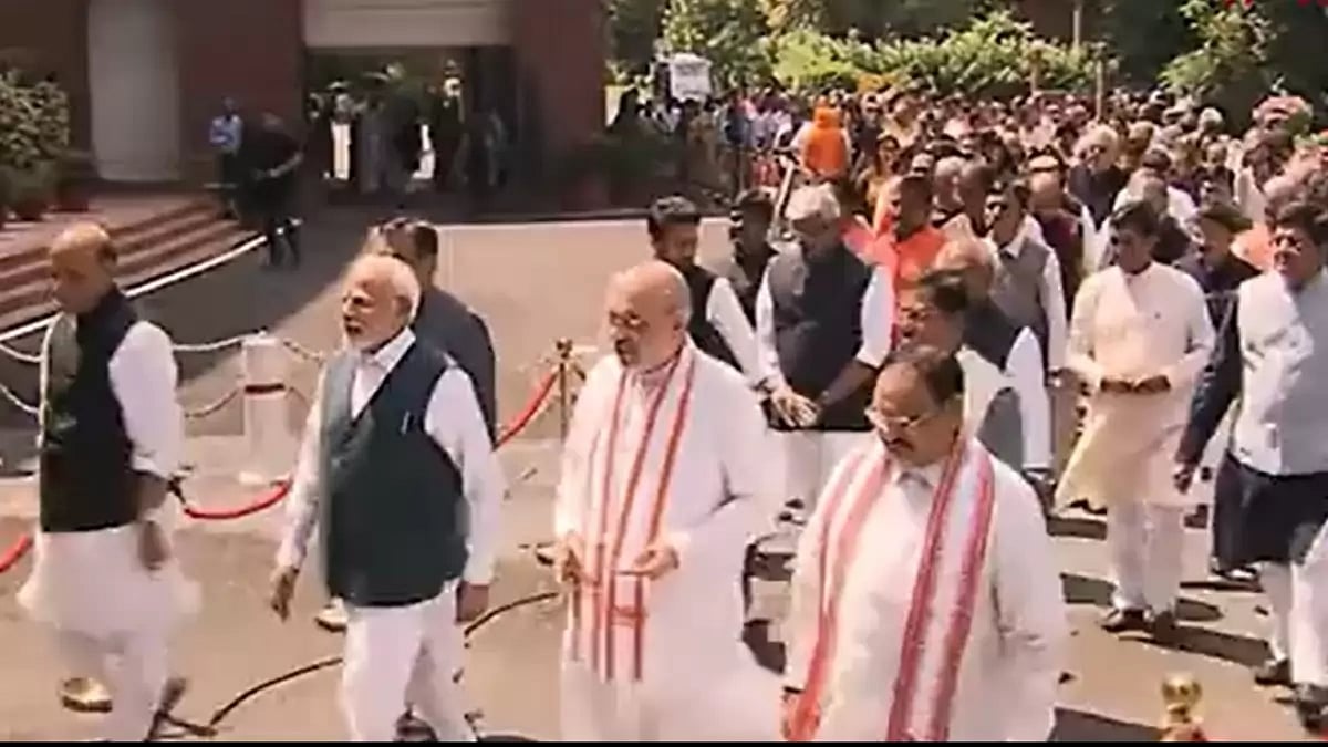 PM Narendra Modi leads the rest of the ministers as they walk into the new Parliament building.