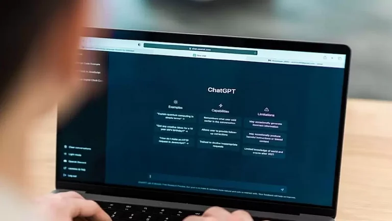 Person using ChatGPT on his laptop - null