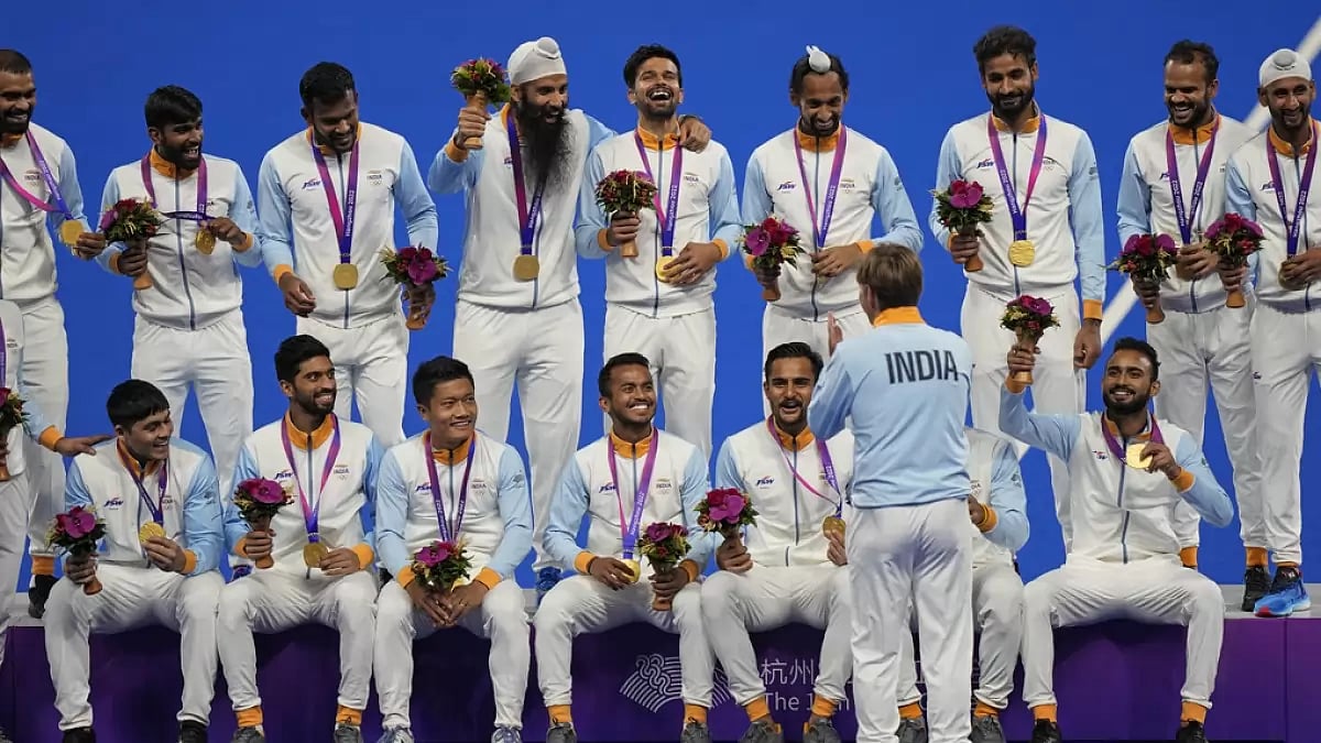 The victorious Indian men's hockey team celebrates on the podium in Hangzhou.