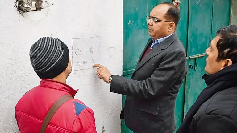 Head Count: Patna District Magistrate Chandrashekhar Singh receives information from residents during the caste census survey in Patna - null