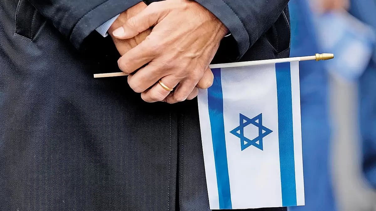 An Israeli supporter holds an Israel flag during a solidarity event in Glencoe, Scotland