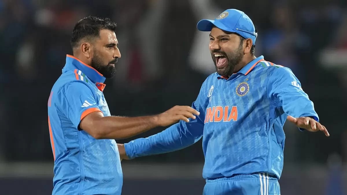 Rohit Sharma (R) and Mohammed Shami celebrate Matt Henrys wicket in Dharamsala.
