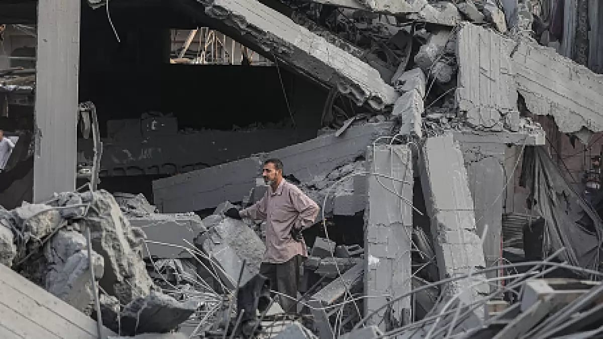 Civil defense teams and residents conduct search and rescue operations in Gaza