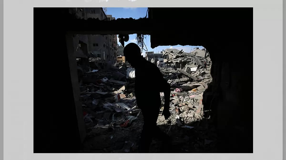 Palestinians gather at a site of Israeli strikes on houses in Bureij camp in the central Gaza Strip.