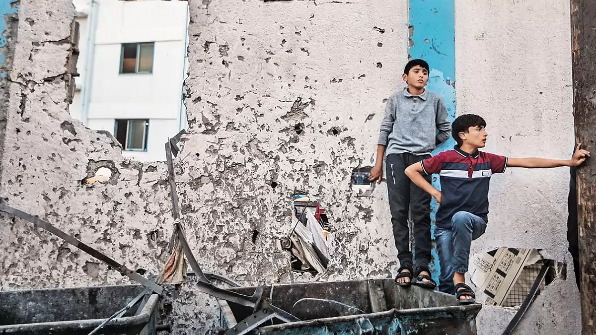 File photo : Amid the Ruins: Palestinians inspect the rubble after an Israeli air strike near a school in the Gaza Strip