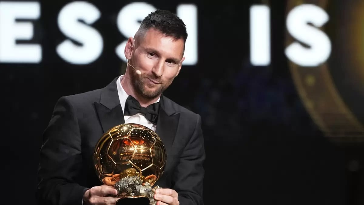 Lionel Messi poses with his Ballon d'Or trophy in Paris.