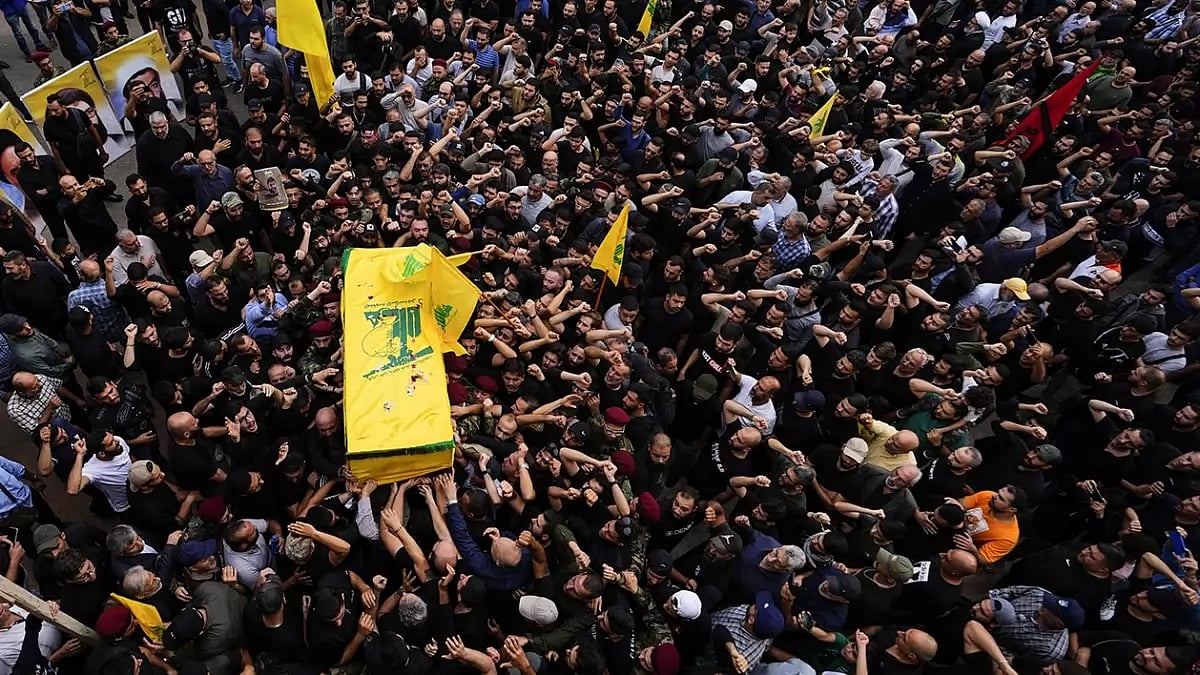 Hezbollah fighters carry the coffin of their comrade