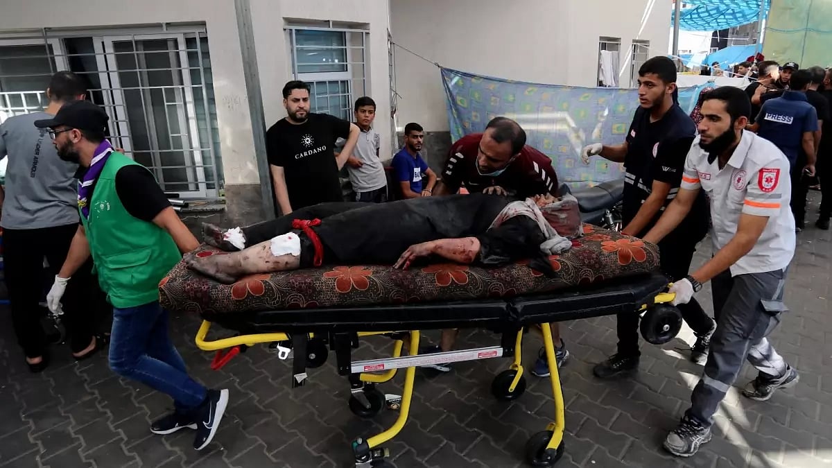 An injured Palestinian woman is wheeled into the al-Shifa hospital, following Israeli airstrikes on Gaza City. 