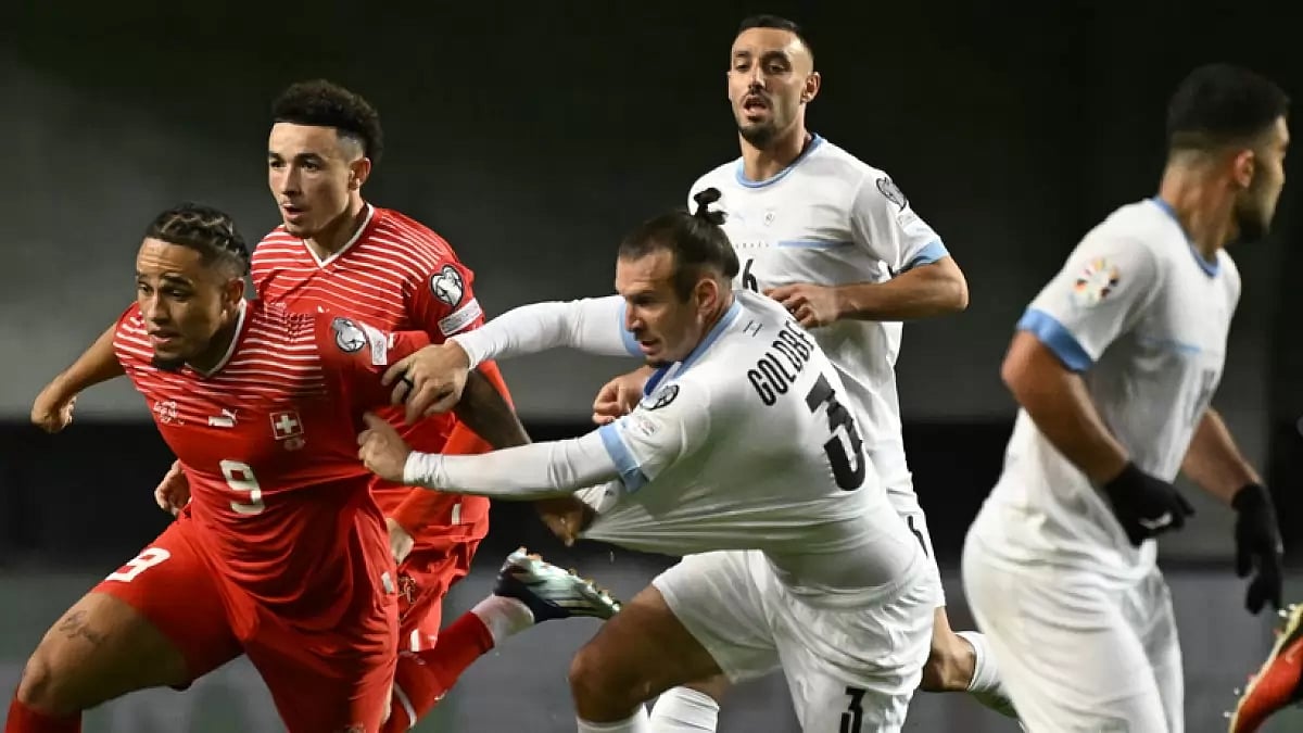 Israel's Sean Goldberg (R) challenges Switzerland's Noah Okafor during the European Championship 2024 Qualifiers